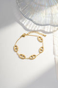 Pulseira de aço dourado com elos ovais abertos